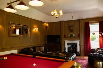 a living room with a pool table in it at Rhumhor House in Carrick