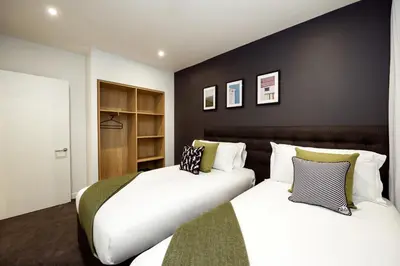 two beds sitting next to each other in a bedroom at Wilde Aparthotels Edinburgh Grassmarket in Edinburgh