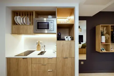 a kitchen with a sink and a microwave at Wilde Aparthotels Edinburgh Grassmarket in Edinburgh