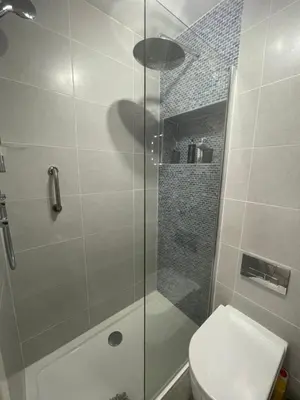 a bathroom with a glass shower with a toilet at Saorsa House Culross in Fife