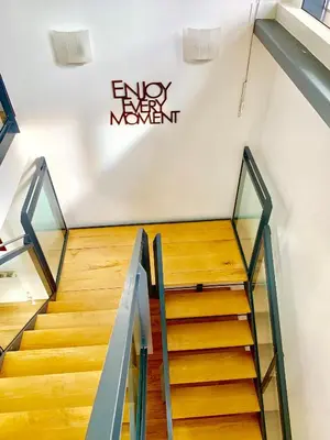 a staircase in a building with a sign on the wall at Glasgow City Centre - The PENTHOUSE with RiverViews - (Duplex, 3 Bedrooms, 3 Bathrooms, 2 Living rooms/Kitchen, Private SKY Terrace, 2 Parkings, Top Floor, Huge - 2100 sq ft, SECC HYDRO) in Glasgow