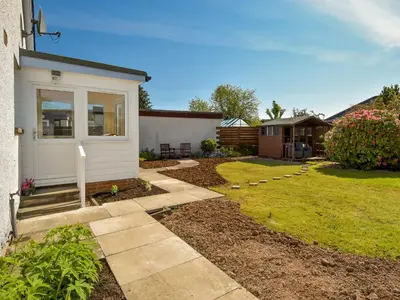 a yard with a house and a garden with a yard sidx sidx sidx at Westburn in Comrie
