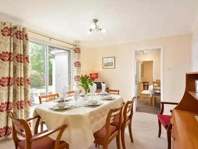 a dining room with a table and chairs at Westburn in Comrie