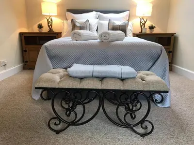 a bedroom with a bed with two towels on it at Chefs cottage in Kenmore