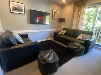 a living room with two couches and a tv at Puffin - Kerrera in Lerags