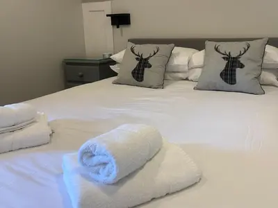 a white bed with towels on top of it at Puffin - Dubh Segir in Lerags