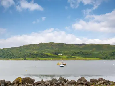 a boat in the middle of a large body of water at Puffin - Dubh Segir in Lerags