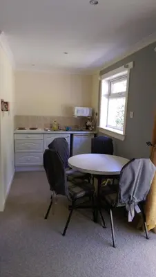a kitchen with a table and chairs in a room at Sir Andrew Murray House in Strathyre