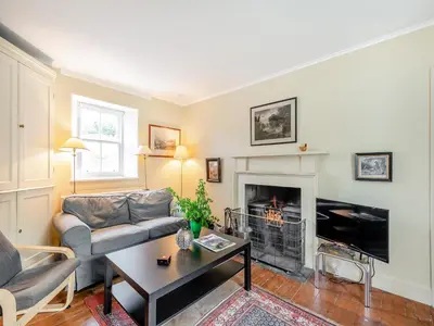 a living room with a couch and a fireplace at Inverglen Farm in Strachur