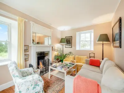 a living room with a couch and a fireplace at Inverglen Farm in Strachur