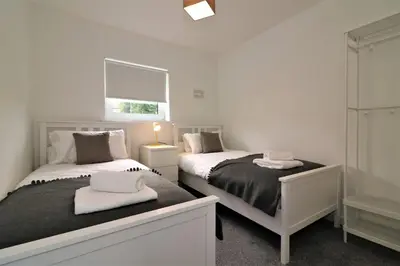 a bedroom with two beds and a window at Signature - Belhaven House in Hamilton