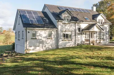 a house with solar panels on the roof at Dunroamin in Drymen