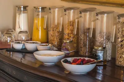 a counter topped with bowls of cereal and fruit at Dunroamin in Drymen