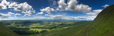 a view of a green valley with clouds in the sky at Dunroamin in Drymen