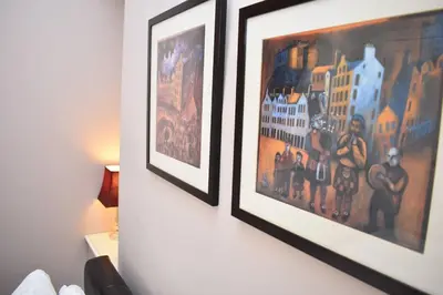 two framed pictures on a wall in a room at West Port - 2BR in the heart of the old town just off the Grassmarket in Edinburgh