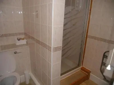a bathroom with a shower and a toilet at Ormidale Hotel in Brodick
