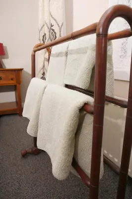 a bed with white towels on it in a room at The Dunning Hotel in Perth