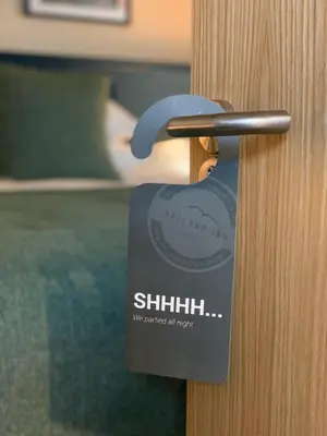 a close up of a door opener on a wooden door at The Balerno Inn in Edinburgh