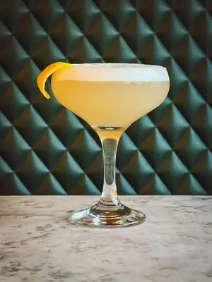 a drink in a martini glass with an orange slice at The Balerno Inn in Edinburgh