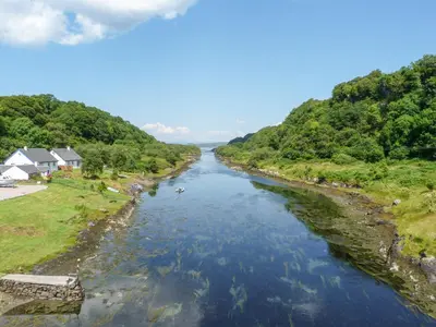 a view of a river from a bridge at Grebe Cottage in Oban