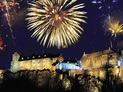 a fireworks display in front of a castle at night at Ginger's in Stirling