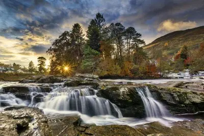 a painting of a waterfall on a river at Ginger's in Stirling