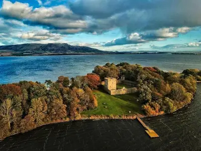 an island in the middle of a body of water at The Old Schoolhouse, Kinross in Kinross