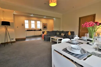 a living room with a couch and a table at Signature - Greenlees Clubhouse 3 Bed in Cambuslang