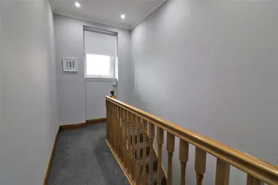 a hallway with a staircase and a window at Signature - Greenlees Clubhouse in Glasgow