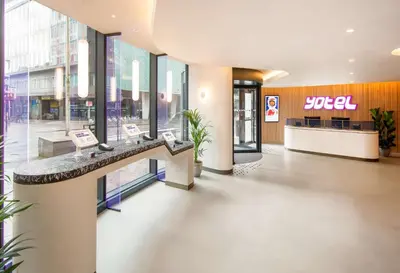 a lobby of a building with a reception desk at YOTEL Glasgow in Glasgow