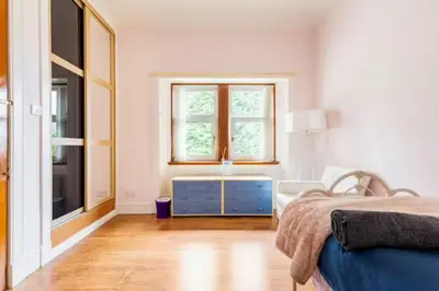 a white bedroom with a bed and a window at Glasgow Emo in Glasgow