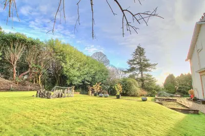 a garden with a playground in the middle of a yard at Duneira House in Helensburgh