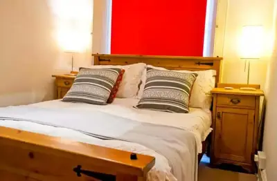 a bedroom with a bed with two pillows on it at Thistle Street Apartment at Heart of the City Centre in Edinburgh