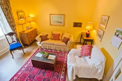 a living room with a couch and a table at Thistle Street Apartment at Heart of the City Centre in Edinburgh