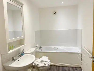 a bathroom with a sink and a tub and a toilet at Cozy Nights - Cambuslang 1/64 in Glasgow