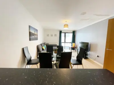 a living room with a dining table and chairs at Cozy Nights - Cambuslang 1/64 in Glasgow