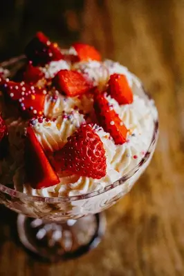 a cake with strawberries on top in a bowl at Coorie Inn Restaurant and Rooms in Crieff