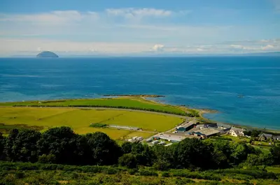 an aerial view of an island in the ocean at Woodland Bay Hotel in Girvan