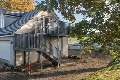 a staircase on the side of a house at Dunroamin Apartment in Drymen