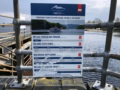 a sign on a fence near the water at Levenhowe Holiday Apartment in Balloch