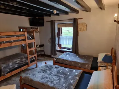 a room with three bunk beds and a window at B&B Drum Farm in Stirling