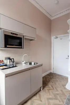 a kitchen with a sink and a counter top at Sweeney Motherwell in Motherwell
