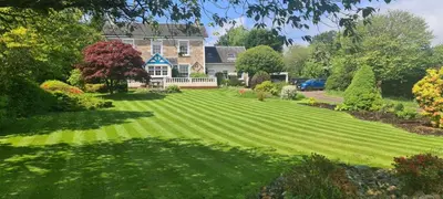 a large lawn in front of a house at CREAG DHUBH COUNTRY HOUSE in Inveraray