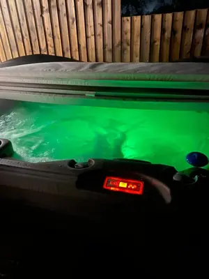 a pool table with green water and a digital clock at COACHMAN COTTAGE OUTSIDE HOT TUB in Beith