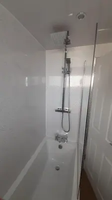 a white bathroom with a shower and a sink at Carvetii - Clark House - Spacious ground floor flat in Rosyth