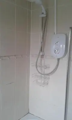 a bathroom with a shower with a sink and a toilet at Carvetii - Derwent House - Spacious 2nd floor flat in Grangemouth