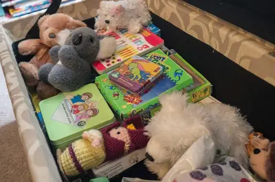 a basket full of stuffed animals and books at Sanaigmore Cottage in Port Charlotte