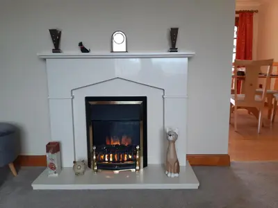 a fireplace in a living room with a fire place at Leafield Holiday Home in Stranraer