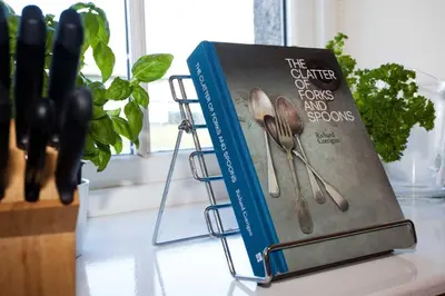a book of forks and spoons sitting on a counter at Ardnave in Port Charlotte