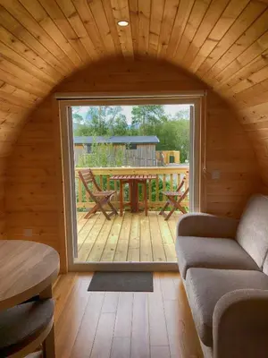 a living room with a large window in a cabin at Tarbert Holiday Park in Tarbert